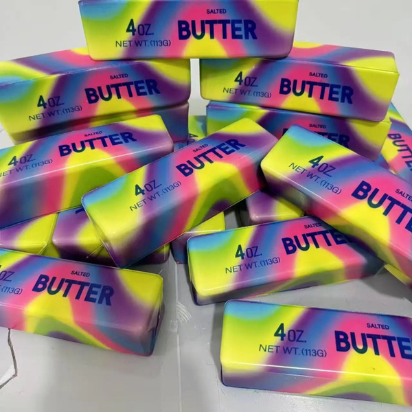 A pile of rainbow tie-dye BUTTER squishy sticks